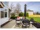 Backyard patio features cozy seating, an outdoor dining table, and well-maintained landscaping, perfect for relaxing at 11686 Belle Plaine Blvd, Fishers, IN 46037