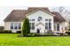A well-kept backyard showing a patio with outdoor furniture and a grill, set against a lush green lawn at 11686 Belle Plaine Blvd, Fishers, IN 46037