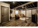 Finished basement with exposed ceiling, stylish seating, and modern flooring, perfect for entertaining at 11686 Belle Plaine Blvd, Fishers, IN 46037