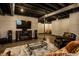 Finished basement offers entertainment area with fireplace, modern furniture, and stylish accents at 11686 Belle Plaine Blvd, Fishers, IN 46037