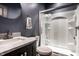 Modern bathroom featuring a vanity with marble countertop and a glass-enclosed shower with built-in shelves at 11686 Belle Plaine Blvd, Fishers, IN 46037