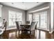 Bright dining area with lots of natural light, neutral tones, and hardwood floors that flow into the kitchen, perfect for entertaining at 11686 Belle Plaine Blvd, Fishers, IN 46037