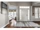 Welcoming foyer with hardwood floors, decorative rug, and elegant trim at 11686 Belle Plaine Blvd, Fishers, IN 46037