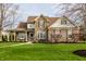 Charming two-story home with stone accents, covered porch, and well-manicured lawn at 11686 Belle Plaine Blvd, Fishers, IN 46037