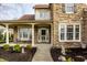 Attractive home with covered porch, stone detailing, and mature landscaping at 11686 Belle Plaine Blvd, Fishers, IN 46037