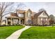 Inviting two-story home with stone facade, covered porch, and lush green lawn at 11686 Belle Plaine Blvd, Fishers, IN 46037