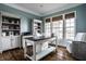 Home office featuring a desk, office chair, built-in shelving, and bright windows at 11686 Belle Plaine Blvd, Fishers, IN 46037