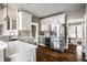 Eat-in kitchen featuring a stainless steel refrigerator, quartz countertops, and custom cabinets, creating a warm and inviting space at 11686 Belle Plaine Blvd, Fishers, IN 46037