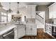 Open kitchen with stainless steel appliances, quartz countertops, and custom cabinets, creating a warm and inviting space at 11686 Belle Plaine Blvd, Fishers, IN 46037