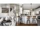 Modern kitchen with stainless steel appliances, white cabinetry, pendant lighting, and a breakfast bar with barstool seating at 11686 Belle Plaine Blvd, Fishers, IN 46037