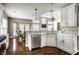 Bright eat-in kitchen featuring stainless steel appliances, quartz countertops, and custom cabinets, creating a warm and inviting space at 11686 Belle Plaine Blvd, Fishers, IN 46037