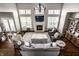 Bright living room boasts high ceilings, fireplace, and a wall of windows for ample natural light at 11686 Belle Plaine Blvd, Fishers, IN 46037