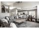 Cozy living room features neutral tones and an open floor plan that flows into the kitchen and dining area, perfect for entertaining at 11686 Belle Plaine Blvd, Fishers, IN 46037
