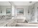 Modern main bathroom featuring a dual vanity, soaker tub, and glass-enclosed shower at 11686 Belle Plaine Blvd, Fishers, IN 46037