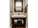 Half bath featuring a modern sink, framed mirror, and storage below at 11686 Belle Plaine Blvd, Fishers, IN 46037