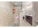 Modern bathroom showcasing a stylish walk-in shower with stone flooring and neutral toned tile surround at 12610 Broadmoor N Ct, Fishers, IN 46037