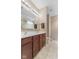 Bathroom with double sink vanity, tile floors, and modern lighting at 12610 Broadmoor N Ct, Fishers, IN 46037