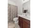 Bathroom featuring a toilet, shower with decorative curtain, and a vanity sink at 12610 Broadmoor N Ct, Fishers, IN 46037