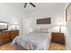 Bedroom with wood floors, two dressers, lamps, ceiling fan, and closet at 12610 Broadmoor N Ct, Fishers, IN 46037