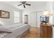 Bright bedroom features a ceiling fan, wood floors, closet and window with natural light at 12610 Broadmoor N Ct, Fishers, IN 46037