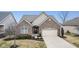 Charming brick home with well-manicured landscaping, a welcoming entrance, and an attached two-car garage at 12610 Broadmoor N Ct, Fishers, IN 46037