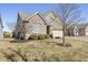 Brick house with a well-maintained lawn and mature trees, offering classic curb appeal and charm at 12610 Broadmoor N Ct, Fishers, IN 46037
