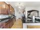 Modern kitchen featuring stainless steel appliances, dark countertops and rich wood cabinetry at 12610 Broadmoor N Ct, Fishers, IN 46037