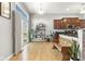 Bright kitchen eating area has wood floors, natural light and sliding glass door access to outdoor balcony at 12610 Broadmoor N Ct, Fishers, IN 46037