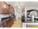 Modern kitchen with stainless steel appliances, dark countertops, mosaic backsplash, and wood flooring at 12610 Broadmoor N Ct, Fishers, IN 46037