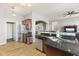 Bright kitchen features stainless appliances, tiled backsplash, dark counters and wood floors with eating area at 12610 Broadmoor N Ct, Fishers, IN 46037