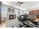 Bright living area featuring a fireplace, hardwood flooring, and a bar with wood panelling at 12610 Broadmoor N Ct, Fishers, IN 46037