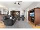 Spacious living room with hardwood floors, a fireplace, and an open view to the kitchen and dining area at 12610 Broadmoor N Ct, Fishers, IN 46037