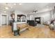 Open-concept living room features hardwood floors, modern lighting, and seamless flow to the kitchen area at 12610 Broadmoor N Ct, Fishers, IN 46037