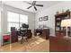 Well-lit home office featuring hardwood floors, a ceiling fan, and two desks with ample workspace at 12610 Broadmoor N Ct, Fishers, IN 46037