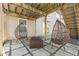 Cozy outdoor patio with egg chairs and stone pavers under a deck provides a tranquil retreat at 12610 Broadmoor N Ct, Fishers, IN 46037