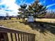 Large backyard with mature trees, a shed, and a fire pit at 12930 River Grove Dr, Columbus, IN 47203