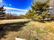 Expansive backyard featuring lush green grass, mature trees, and playground equipment at 12930 River Grove Dr, Columbus, IN 47203