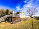 A spacious wooden deck overlooking a backyard, enhanced by lush greenery and a classic wooden fence at 12930 River Grove Dr, Columbus, IN 47203