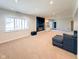 Spacious carpeted basement with a cozy seating area, a fireplace, and recessed lighting at 12930 River Grove Dr, Columbus, IN 47203