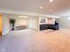 Spacious carpeted basement with recessed lighting, a seating area and an adjacent dining area at 12930 River Grove Dr, Columbus, IN 47203