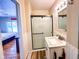 Well-lit bathroom featuring a vanity with a marble countertop and a black-framed glass door shower at 12930 River Grove Dr, Columbus, IN 47203