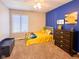 Vibrant bedroom with blue accent wall, plush carpet, and neutral walls at 12930 River Grove Dr, Columbus, IN 47203