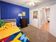 Cheerful bedroom with blue accent wall and plush carpeting at 12930 River Grove Dr, Columbus, IN 47203