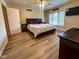Bright bedroom with hardwood floors, ceiling fan, natural light, and a comfortable king-size bed at 12930 River Grove Dr, Columbus, IN 47203