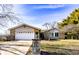 A single-story home featuring a stone facade, attached garage, and a well-maintained front yard at 12930 River Grove Dr, Columbus, IN 47203