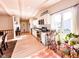 Sunlit kitchen with white cabinets, black countertops, stainless steel appliances, and plants at 12930 River Grove Dr, Columbus, IN 47203