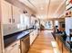 Well-lit kitchen featuring stainless steel appliances, black counters, and open flow to dining area at 12930 River Grove Dr, Columbus, IN 47203