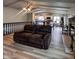 Open floor plan with kitchen, dining area, and living area with wood floors and fireplace at 12930 River Grove Dr, Columbus, IN 47203