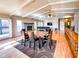 Open-concept living room with vaulted ceilings, fireplace, wood floors, and access to an outdoor deck at 12930 River Grove Dr, Columbus, IN 47203