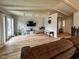 Bright living room featuring a TV, wood floors, bench and glass patio doors at 12930 River Grove Dr, Columbus, IN 47203